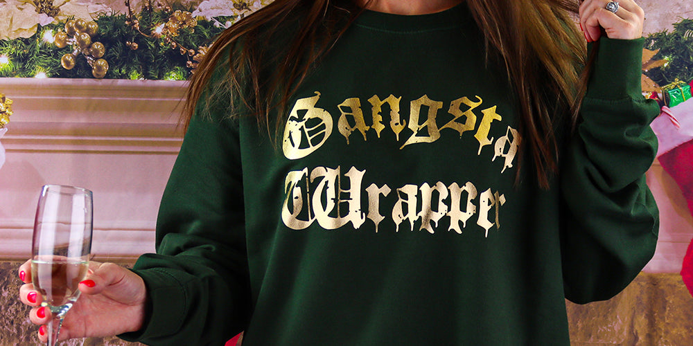 green and gold christmas jumper with the wording gangsta wrapper on the front in fashion gold, great new style christmas jumper for the festive season