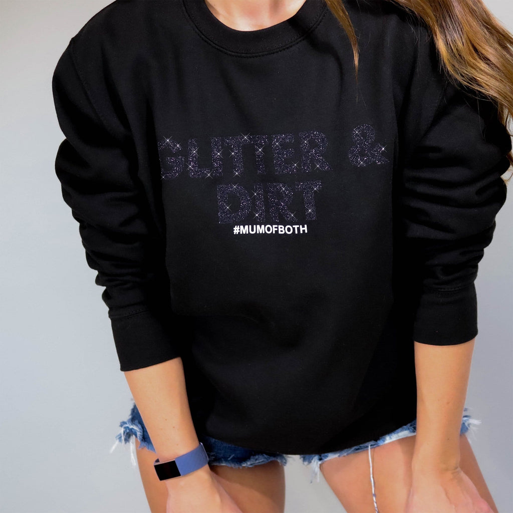 Woman wearing Black Sweater with Black Glitter and white wording which reads "Glitter and Dirt Mum of Both" Made by Original Monkey 