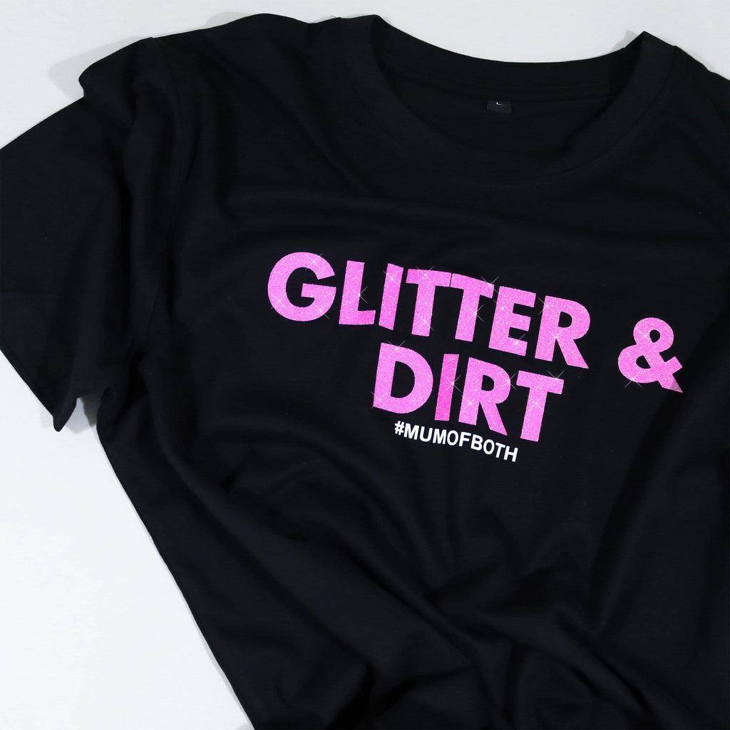 Woman wearing black T shirt with pink glittery text reading 'glitter and dirt #mum of both' by Original Monkey Gifts.