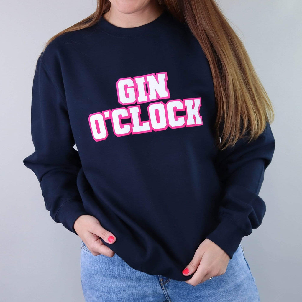 Navy sweater with text reading 'Gin Oclock' that can be personalised by Original Monkey Gifts, worn with blue denim jeans. 