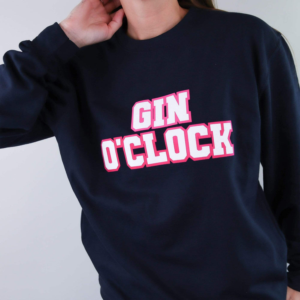Navy sweater with text reading 'Gin Oclock' that can be personalised by Original Monkey Gifts, worn with blue denim jeans.