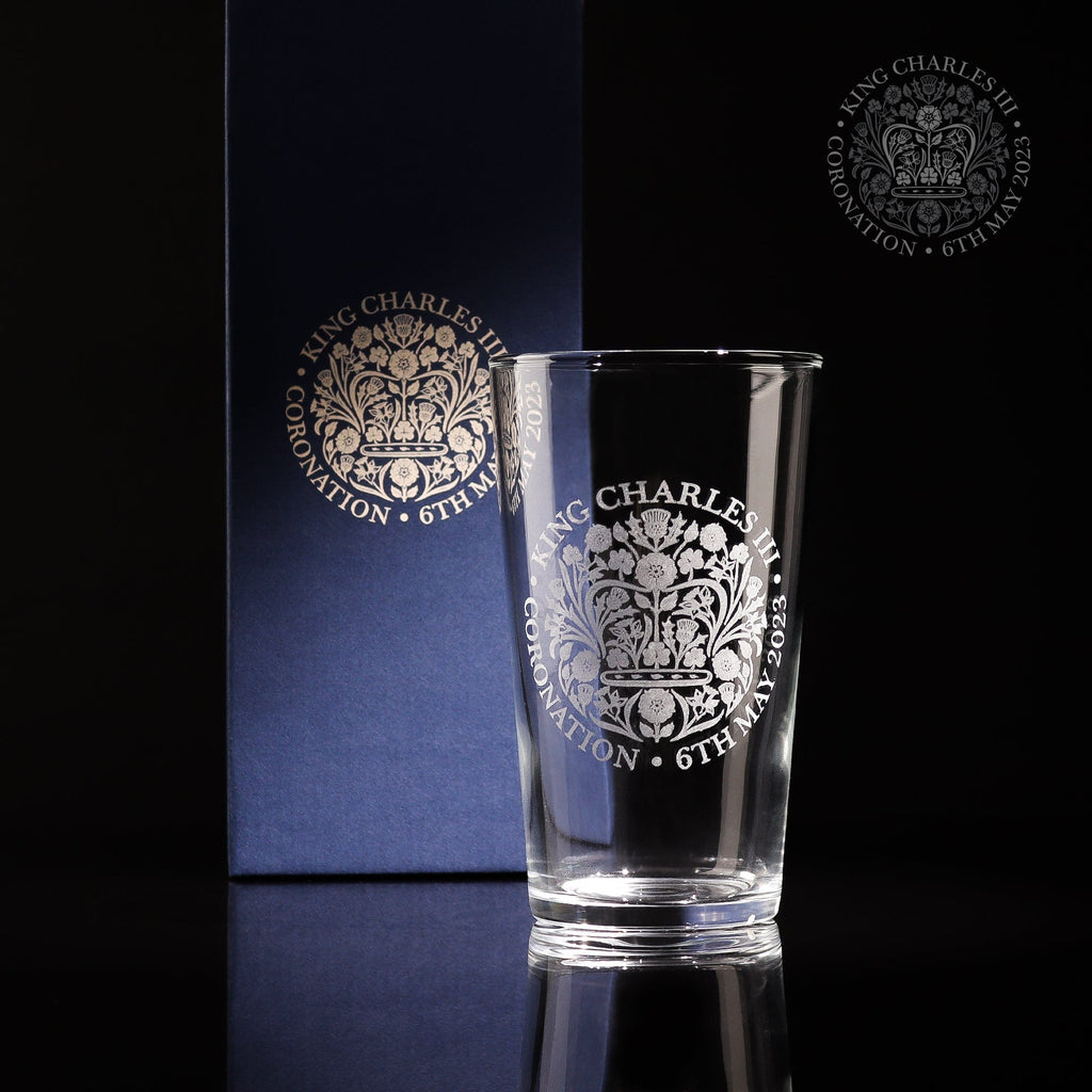 A beautiful pint glass engraved with the official emblem for the coronation of King Charles III the glass comes with a gift box which is also engraved with the same logo making it a great for any collection of royal memorabilia