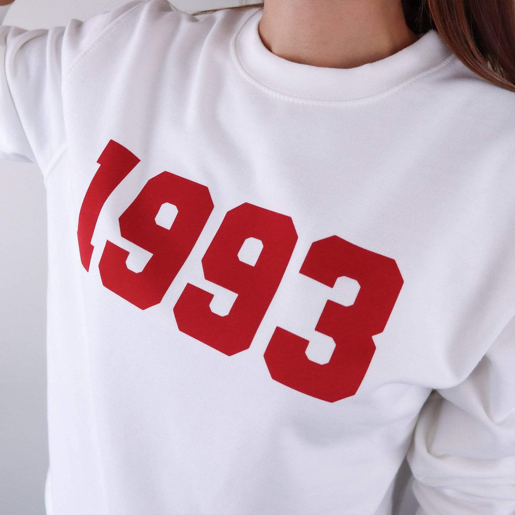 Woman wearing white hoodie with personalised year of 1993 in red text by Original Monkey