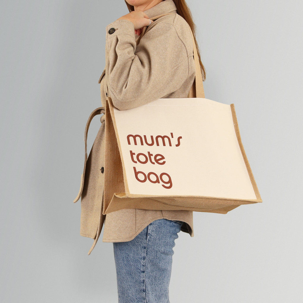 women wearing a natural coloured tote bag with the wording mum's tote bag on it, the wording can be personalised
