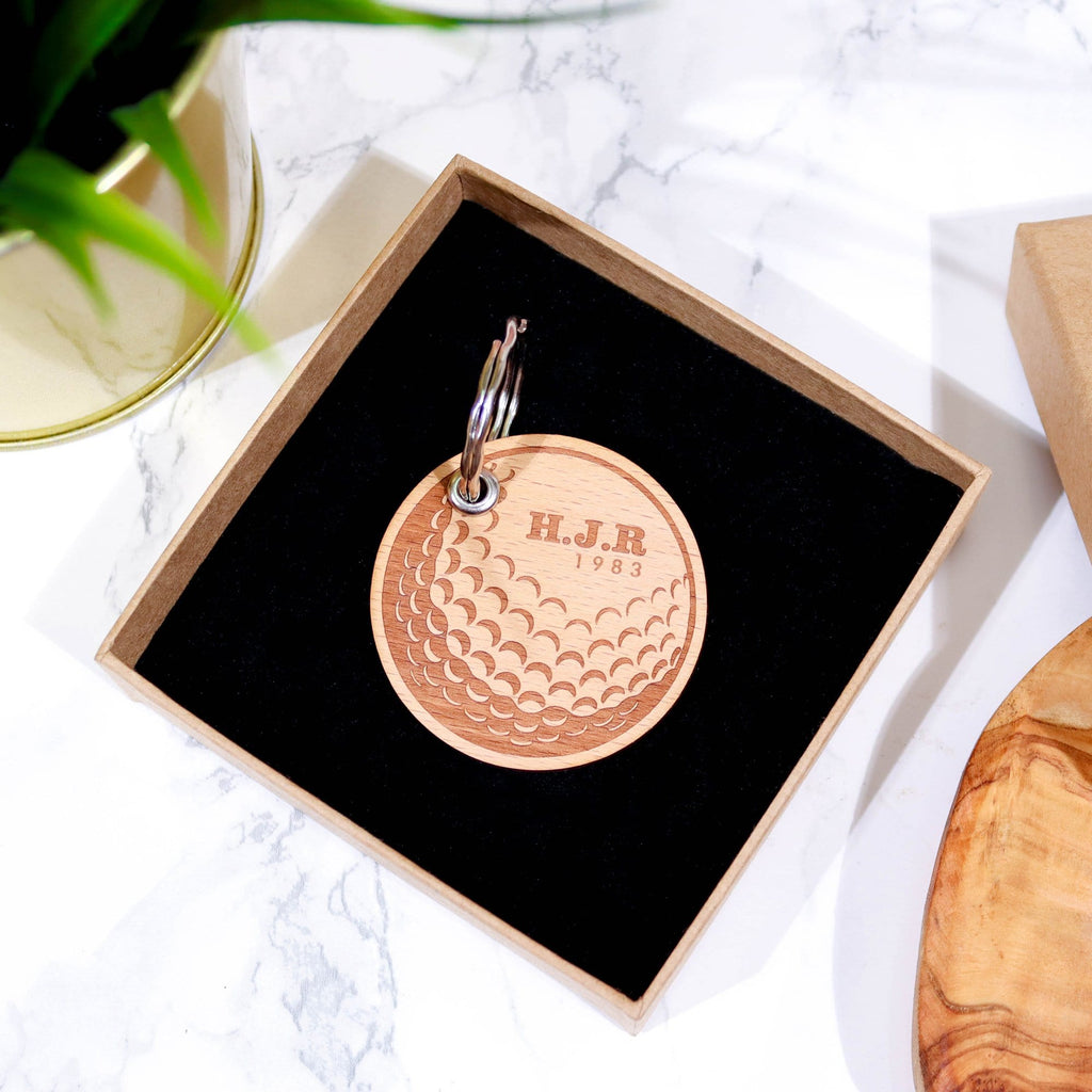 Circular wooden keyring with gold ball design and initials engraved on top by Original Monkey Gifts.