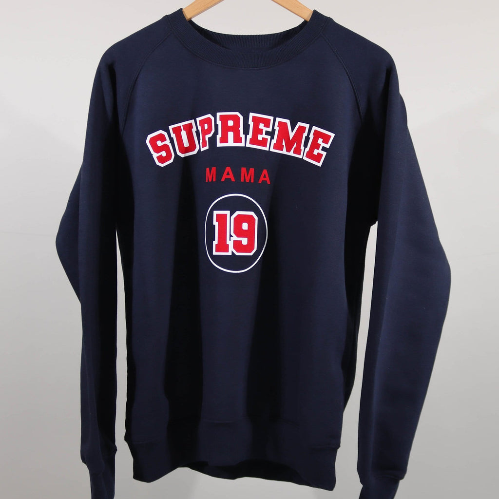 Woman wearing navy blue sweater with personalised Supreme Mama 19 in Red and white and is worn with blue denim jeans. By Original Monkey Gifts