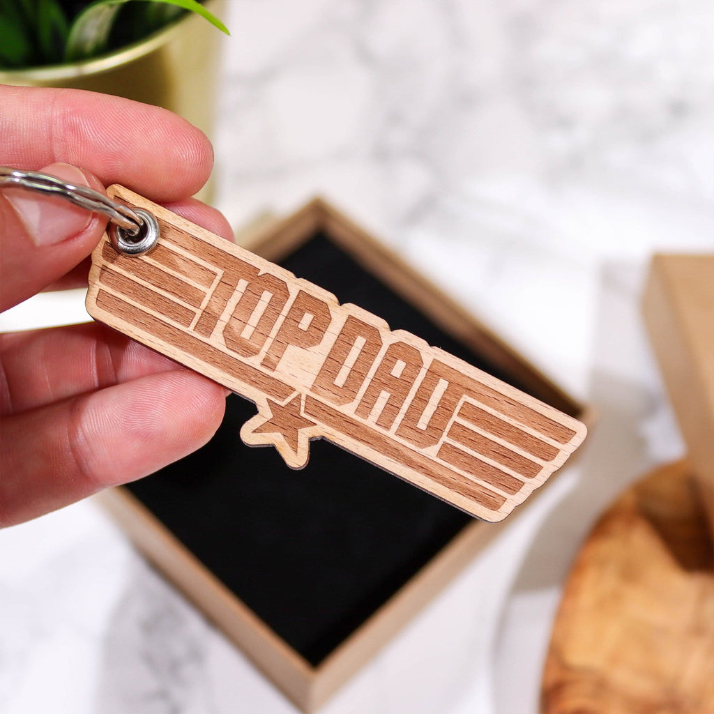 Wooden keyring with engraving that reads 'top dad' in gift box with black insert by Original Monkey Gifts.
