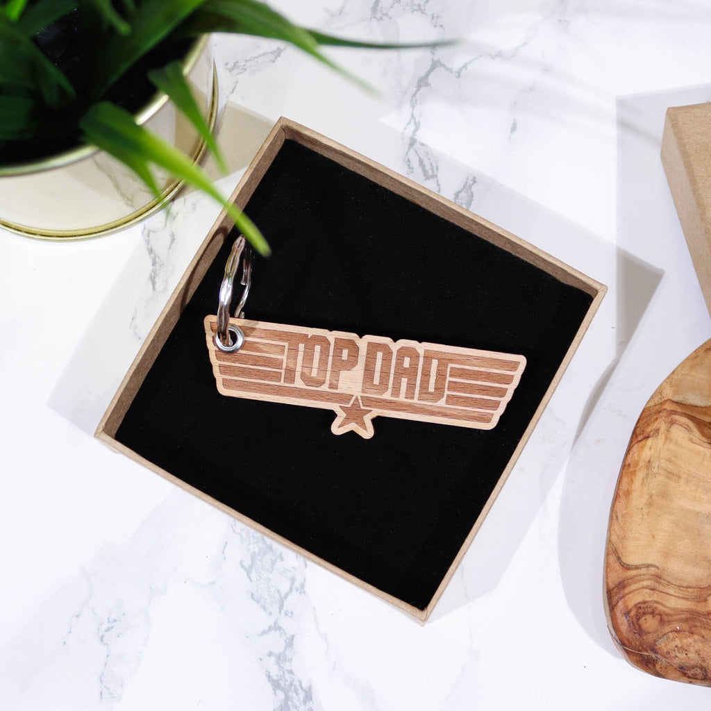 Wooden keyring with engraving that reads 'top dad' in gift box with black insert by Original Monkey Gifts.