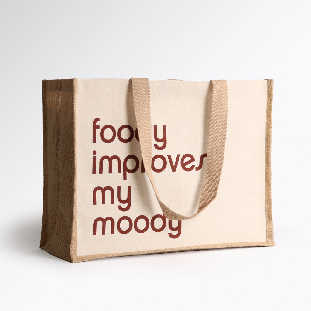a brown and cream tote bag with a design on the front saying 'foody improves my moody'