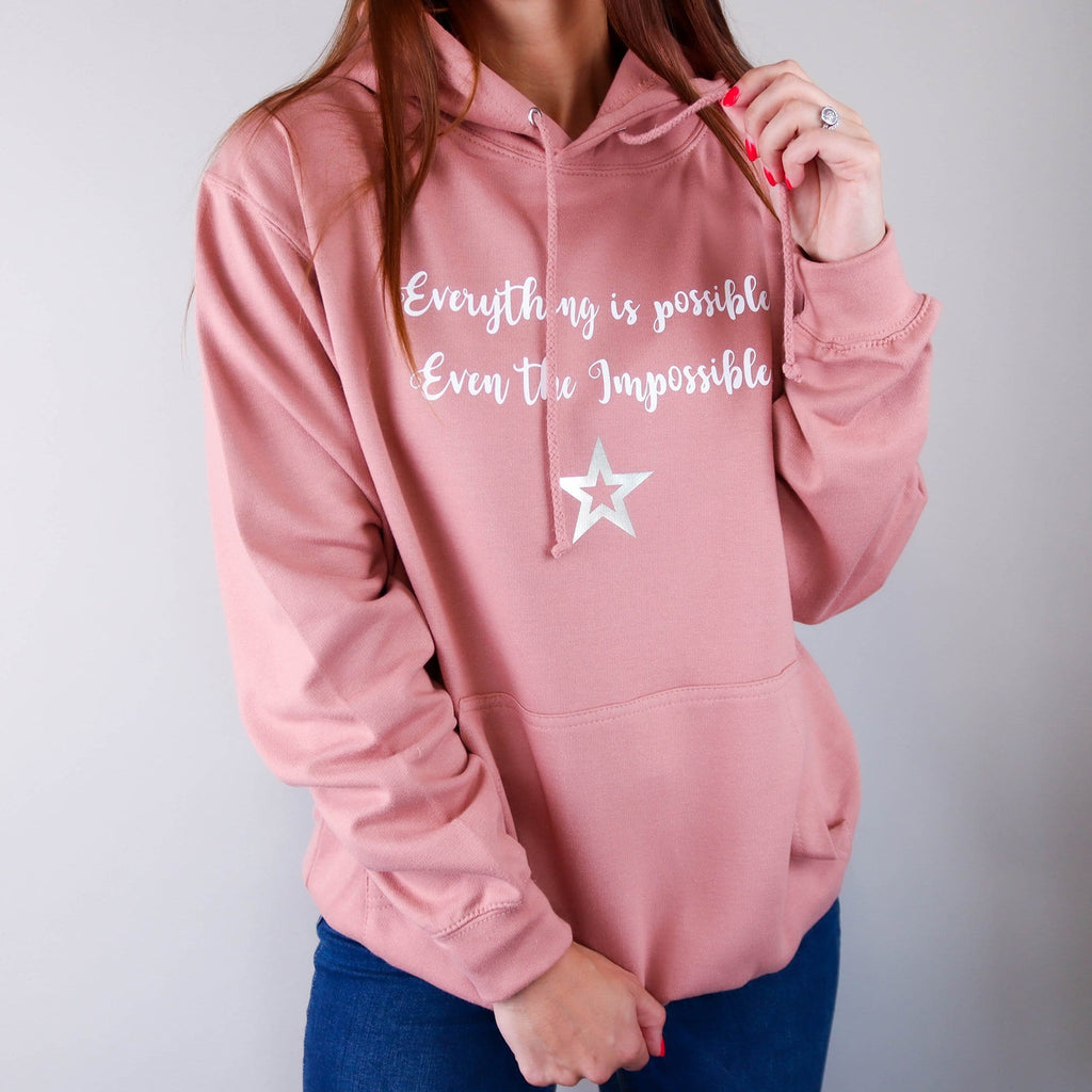 Women wearing Dusty Pink Hoodie with text reading "Everything is possible even the impossible" with white lettering. Made by Original Monkey