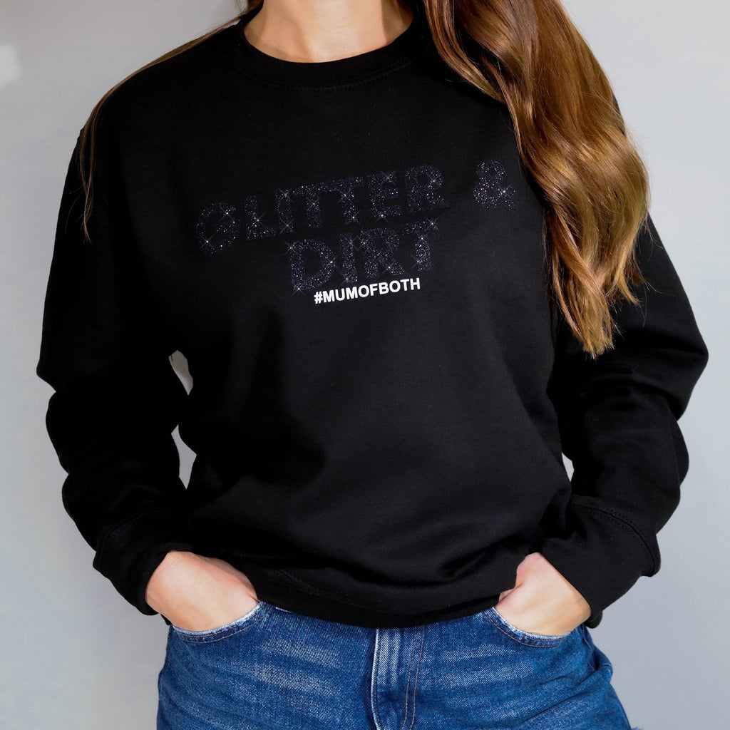 Woman wearing Black Sweater with Black Glitter and white wording which reads "Glitter and Dirt Mum of Both" Made by Original Monkey 