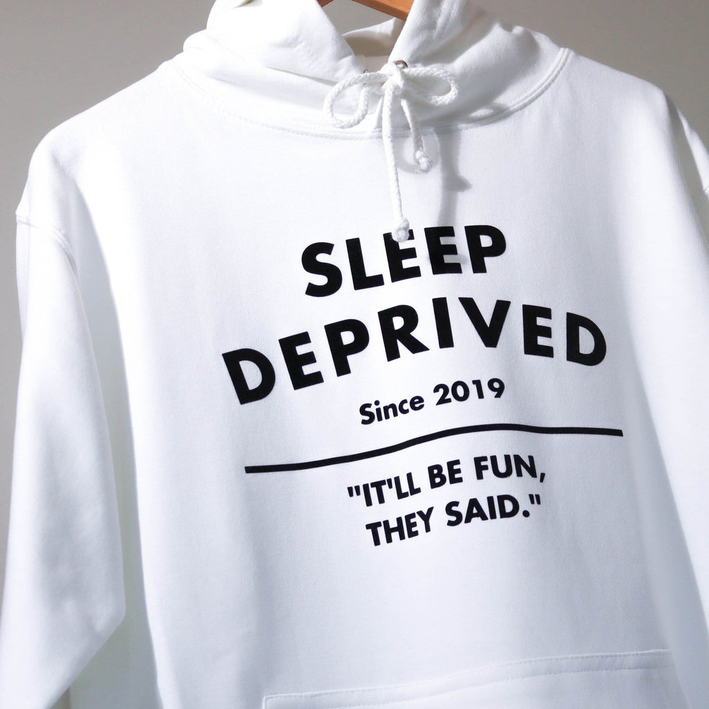 Woman wearing white hoodie with sleep deprived written in black with personalisation. By Original Monkey Gifts