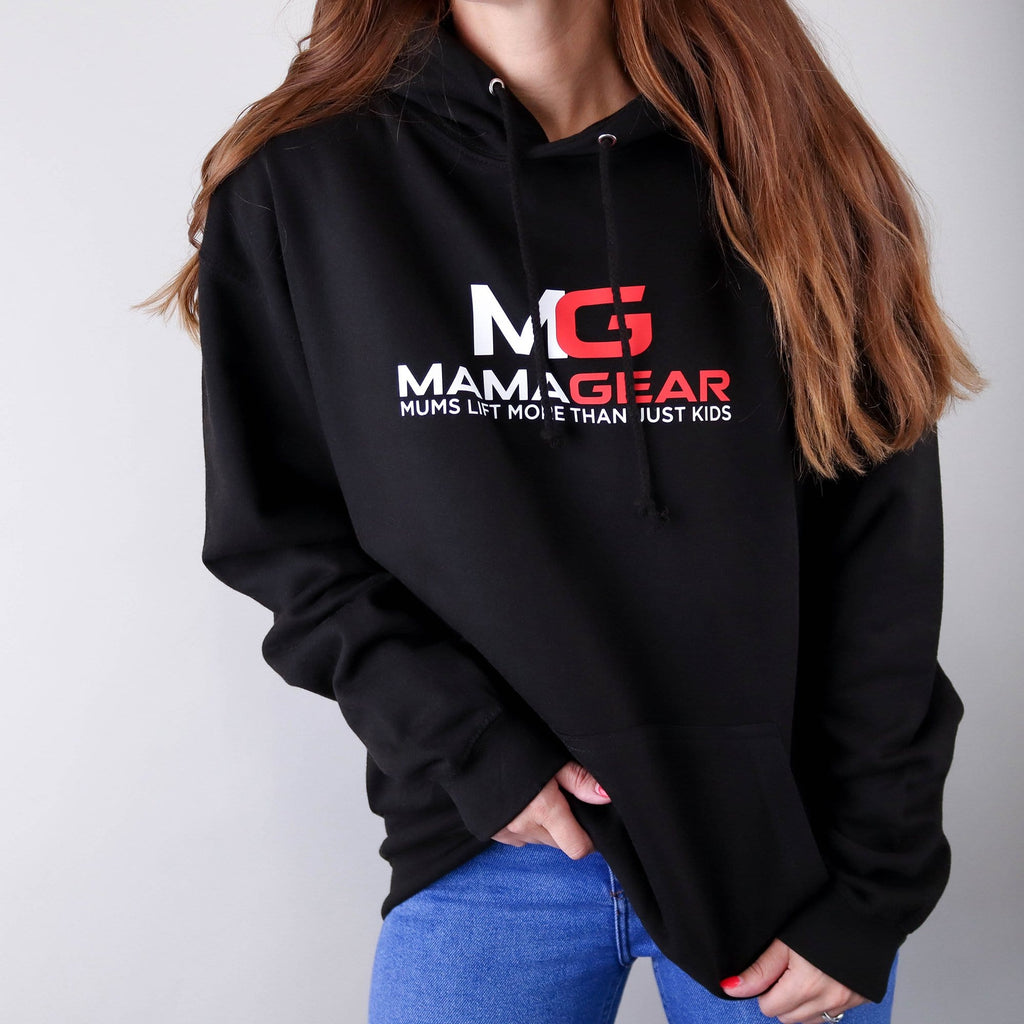 Woman wearing a black hoodie with white and red text reading MamaGear, mum's lift more than just kids, paired with blue jeans. By Original Monkey Gifts