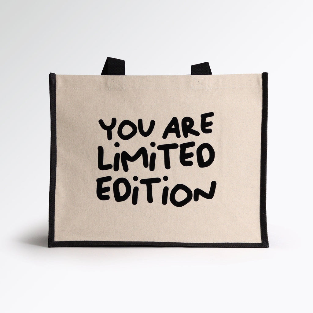 a black and natural tote bag with a quote on the front saying "you are limited edition" lovely shopping bag