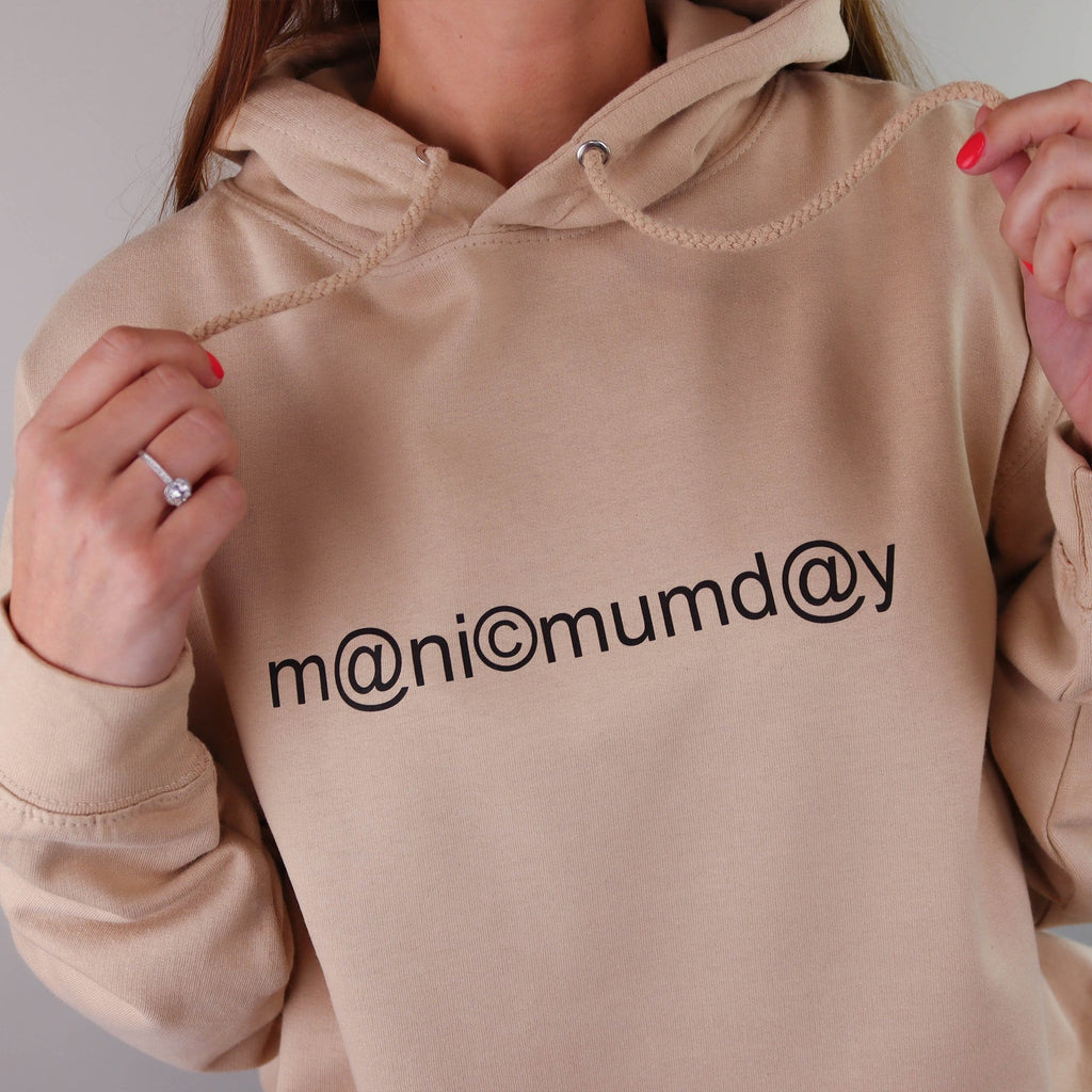 A woman wearing a sand coloured hoodie which says manic mumday creating a great gift idea for any mum made by Original Monkey Gifts