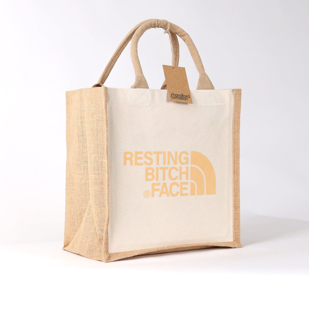 a natural coloured tote bag with the wording resting bitch face on it, a really high quality tote luch bag by handford and mason