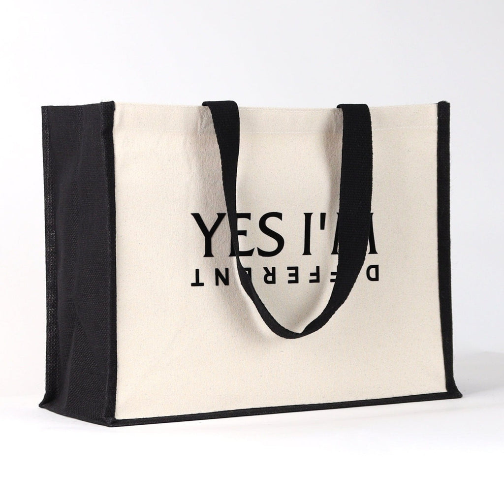 a black and natural tote bag with a black desin on the front that says "yes I'm different" a great fashionable bag for life